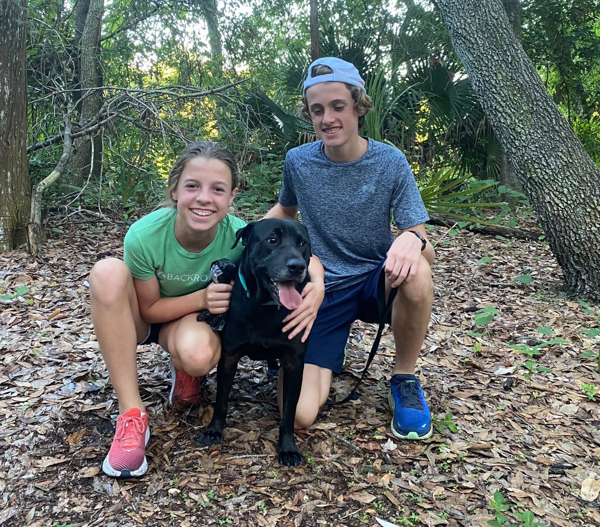 Siblings Blake Peifer, 14, and Brady Peifer, 17 – both students at Steinbrenner High School in Lutz, Fla. – with shelter dog Pantera during a run in June 2022.  (Courtesy of Margaret Peifer)