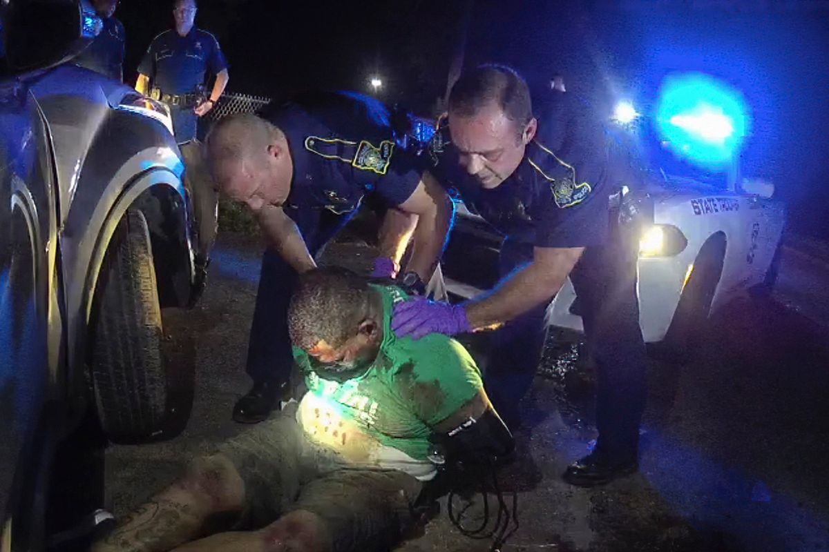 FILE - This image from the body camera video of Louisiana State Police Trooper Dakota DeMoss shows his colleagues, Kory York, center left, and Chris Hollingsworth, center right, holding up Ronald Greene before paramedics arrived on May 10, 2019, outside of Monroe, La. Louisiana lawmakers investigating the deadly 2019 arrest of Greene are preparing to hold Kevin Reeves, the former head of the state police, in contempt for refusing to turn over his journals after talks broke down Monday, May 2, 2022, in a dispute over an entry mentioning Gov. John Bel Edwards.  (HOGP)