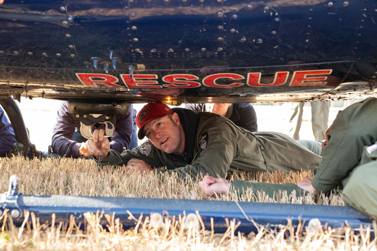 Spokane County Deputy Sheriff Chris Byslow performs a tension check on equipment fastened to the underbelly of a Huey helicopter during day three of training on Oct. 5, 2018 at River City Helicopters in Post Falls, Idaho. Roughly 15 members of the Spokane City, Spokane Valley, and Coeur d