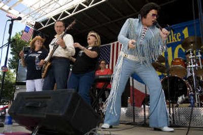 
Presidential hopeful and former Arkansas Gov. Mike Huckabee plays bass with his band as an Elvis impersonator helps out with 