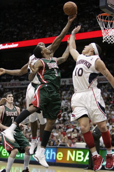 Bucks guard Brandon Jennings goes up for a layup as Atlanta’s Joe Johnson, behind, blocks the shot during Atlanta’s 95-74 win. (Associated Press)