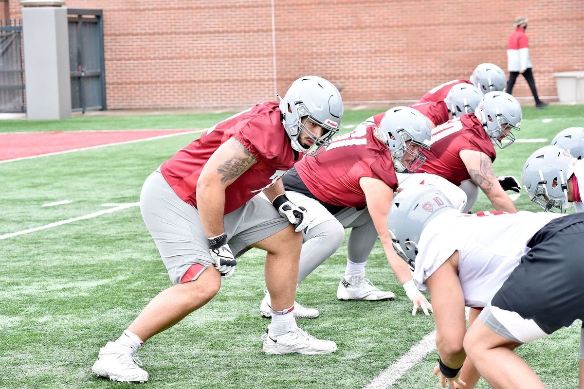 Washington State right tackle Abe Lucas gets in his stance before the ball is snapped at the Cougars’ practice on Saturday at Rogers Field in Pullman.  (Washington State Athletics)