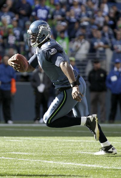 Quarterback Tarvaris Jackson runs for a second-half touchdown that provided the winning margin in Seattle’s 13-10 victory over the Arizona Cardinals on Sunday. (Associated Press)