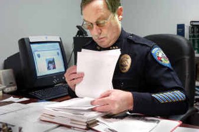
With Cody Haynes pictured on his computer, Kittitas Police Chief Steve Dunnagan looks through the file of reports and contacts generated since Sept. 12. 
 (Christopher Anderson photos/ / The Spokesman-Review)
