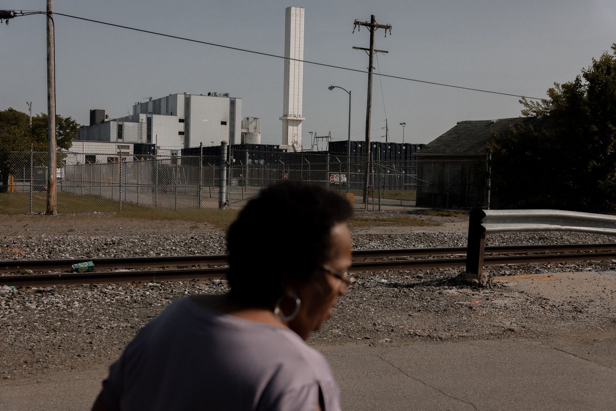Zulene Mayfield walks on a residential street near the Covanta incineration facility. (MUST CREDIT: Photo for The Washington Post by Caroline Gutman)  (Caroline Gutman/For Washington Post)