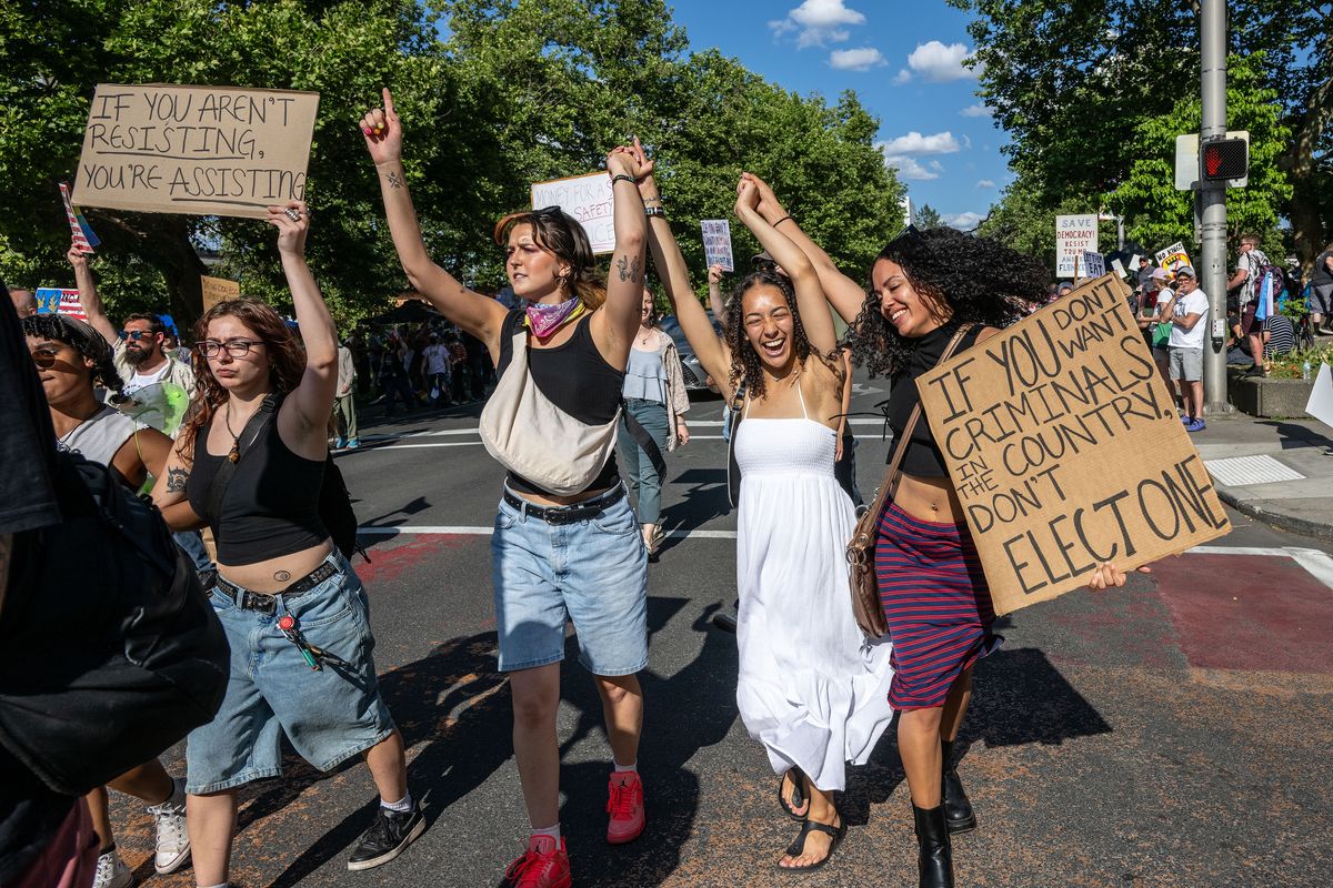 Some protesters broke out of the crowd and marched through downtown Spokane during the No Kings rally and march. Thousands of protesters crowded Riverfront Park and lined Spokane Falls Boulevard on Saturday afternoon to protest policies of President Donald Trump. (COLIN MULVANY)
