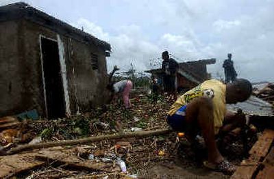 
A family cleans up their house after the passing of Hurricane Ivan in the outskirts of Kingston, Jamaica, on Sunday. 
 (Associated Press / The Spokesman-Review)