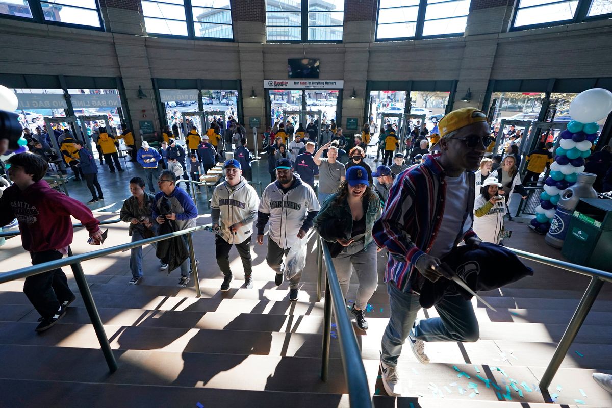 Fans arrive at T-Mobile Park before a baseball game between the Seattle Mariners and the Houston Astros, Friday, April 15, 2022, in Seattle.  (Associated Press)