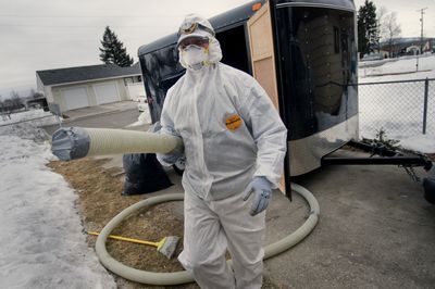 John Custer, an insulation contractor with Spokane Neighborhood Action Programs,  helps weatherize a house Tuesday in Hillyard.  Washington Senate Democrats have a plan that combines low-tech projects, such as doing more to make homes energy-efficient, to higher-tech ideas.  (Colin Mulvany / The Spokesman-Review)