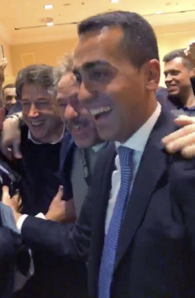 In this frame taken from a video provided by the Five-Star Movement, movement ‘s Leader Luigi Di Maio, right, and other movement members look at the first results of the Italian general elections in Rome, Monday, March 5, 2018. Sunday’s vote is one being watched to see if Italy will succumb to the populist, euroskeptic and far-right sentiment that has swept through Europe in recent years. (Associated Press)