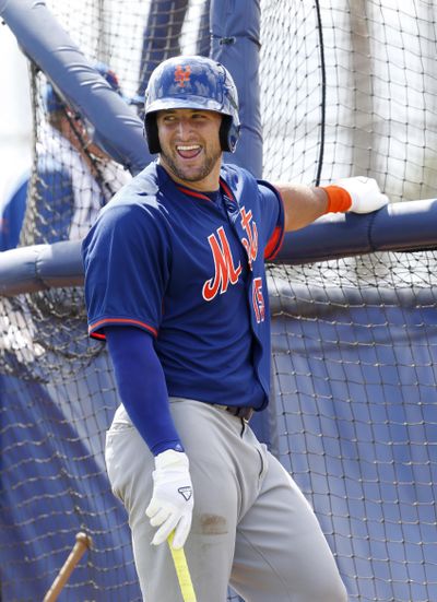 Tim Tebow laughs as he waits his turn for his turn in the batting cage. (Wilfredo Lee / Associated Press)