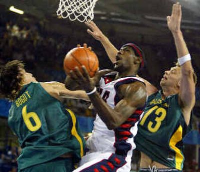 
Lebron James cuts between Australia's Andrew Bogut, left, and David Andersen during their game on Thursday.   
 (Associated Press / The Spokesman-Review)