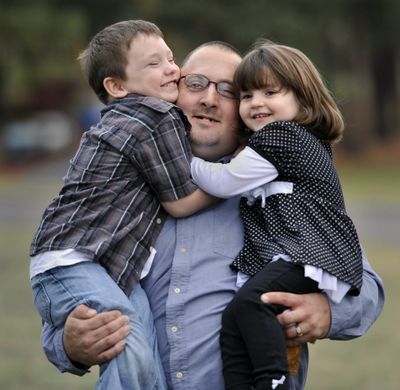 Five-year-old Braxton Ruetsch, left, is pictured with his father, Phil Ruetsch and sister, Caitlynn, 3. Braxton  is  being honored by the local chapter of the American Red Cross as a Hometown Hero. He summoned help after a golf cart carrying the three of them  flipped, pinning his father under it.  (Dan Pelle)