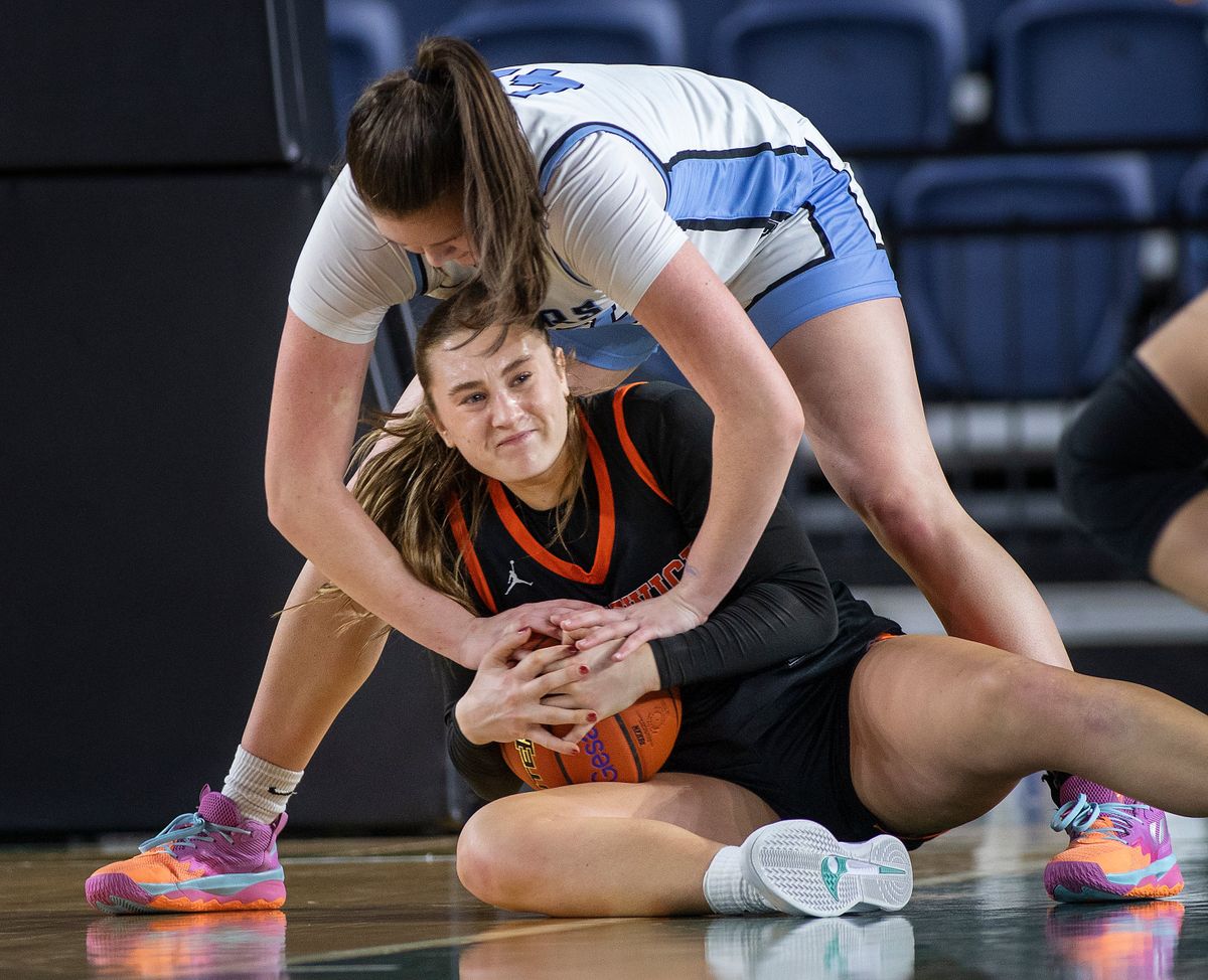Central Valley’s Brynn McGaughy, above, ties up Kennewick’s Rylee Bendewald during action in the 3A Girls State Basketball Tournament Thursday, March 6, 2025, in Tacoma, Wash. Central Valley defeated Kennewick 45-37 to advance.  (Patrick Hagerty)