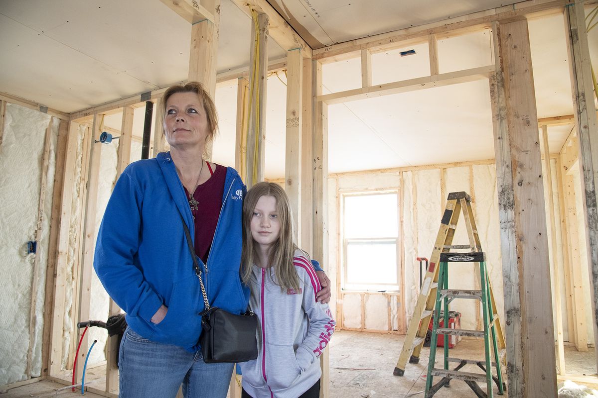 Dianna Totten and daughter Briaunna Totten, 12, stand inside their new home in Malden, Washington, Monday, Mar. 1, 2021. Totten lost her home in the Labor Day fire last year and the new structure is being built by a group of volunteers.  (Jesse Tinsley/The Spokesman-Review)