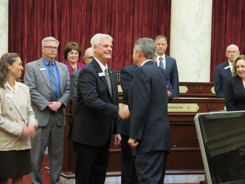 Senate President Pro-Tem Brent Hill, R-Rexburg, is congratulated by Lt. Gov. Brad Little and senators of both parties after being sworn in for another term in the Senate's top leadership post. (Betsy Z. Russell)
