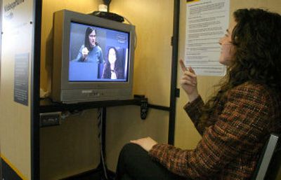 
Gallaudet University graduate Terri Vincent, bottom right screen, signs to a video relay service interpreter who is calling Vincent's boyfriend. Thanks to VRS, a phone conversation with a deaf person is no longer a dry, impersonal affair.
 (The Washington Post / The Spokesman-Review)