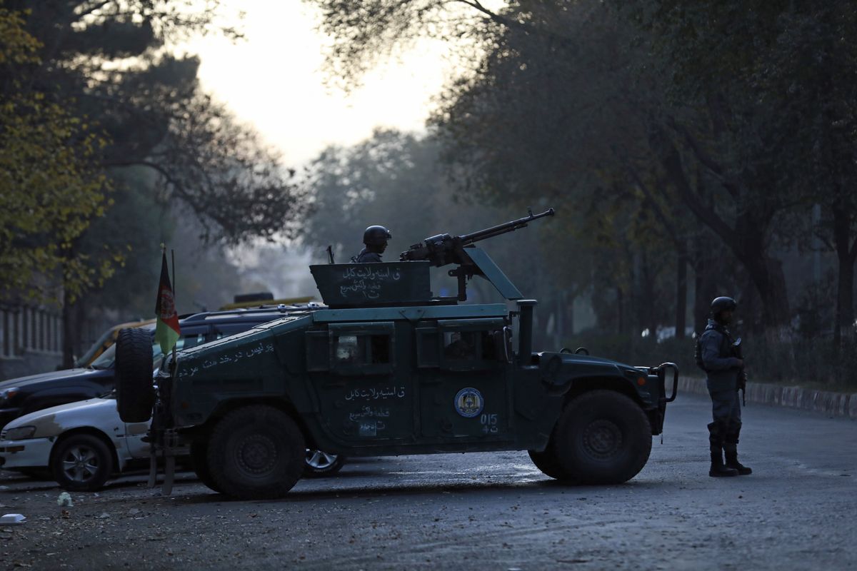 Afghan police patrol at the site of an attack at Kabul University in Kabul, Afghanistan, Monday, Nov. 2, 2020. The brazen attack by gunmen who stormed the Kabul University has left many dead and wounded in the Afghan capital. The assault sparked a hours-long gunbattle.  (Rahmat Gul)