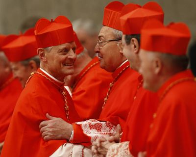 Newly appointed U.S. Cardinal Donald W. Wuerl, left, is congratulated by other cardinals after being elevated by Pope Benedict XVI  on Saturday.  (Associated Press)