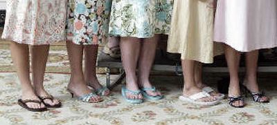 
Despite their below-the-knee hemlines, a mini-controversy erupted after members of the Northwestern University women's lacrosse team wore flip-flops to meet President Bush at the White House.
 (Associated Press / The Spokesman-Review)