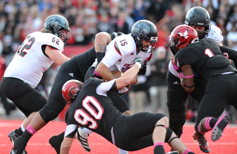 Eastern Washington defensive lineman Evan Day (90) brings down Southern Utah quarterback Aaron Cantu (15)during the first half of a college football game on Saturday, October 19, 2013, at Roos Field in Cheney, Wash. (Tyler Tjomsland / The Spokesman-Review)