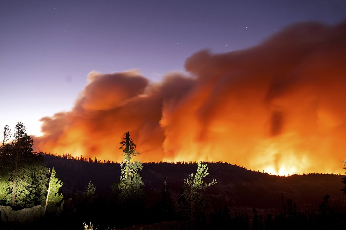 The Caldor Fire burns Aug. 29 in Eldorado National Forest, Calif., in this photo taken with a long camera exposure.  (Noah Berger)