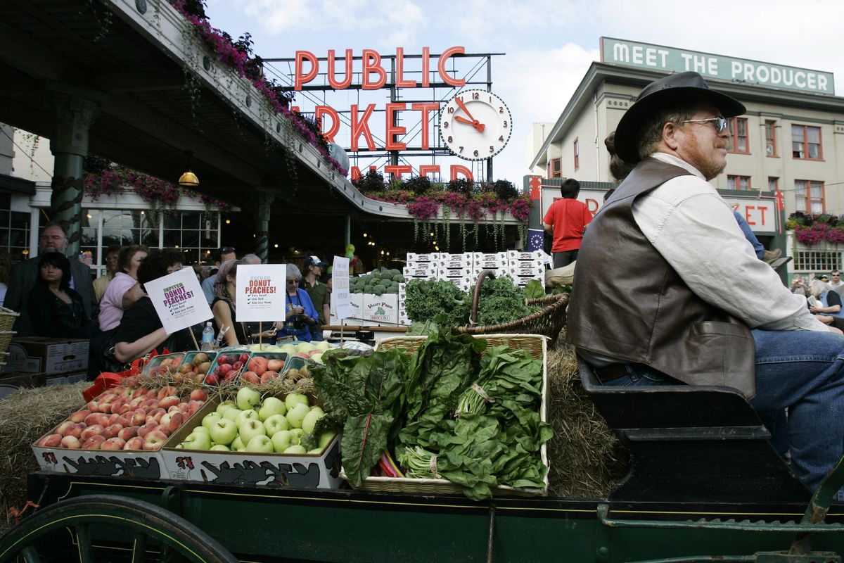 A horse-drawn produce wagon driven by Wayne Buckner of Falls City, Wash., sits at the Pike Place Market in Seattle during the celebration of the 100th anniversary of the public produce market in 2007.