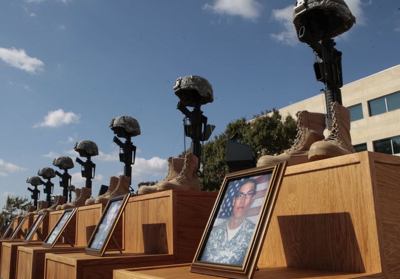 A Soldiers Cross, honoring those who lost their lives in last week's shooting, is seen near the podium where President Barack Obama will speak at the memorial service Tuesday, Nov. 10, 2009, at  Fort Hood, Texas.  (Associated Press)