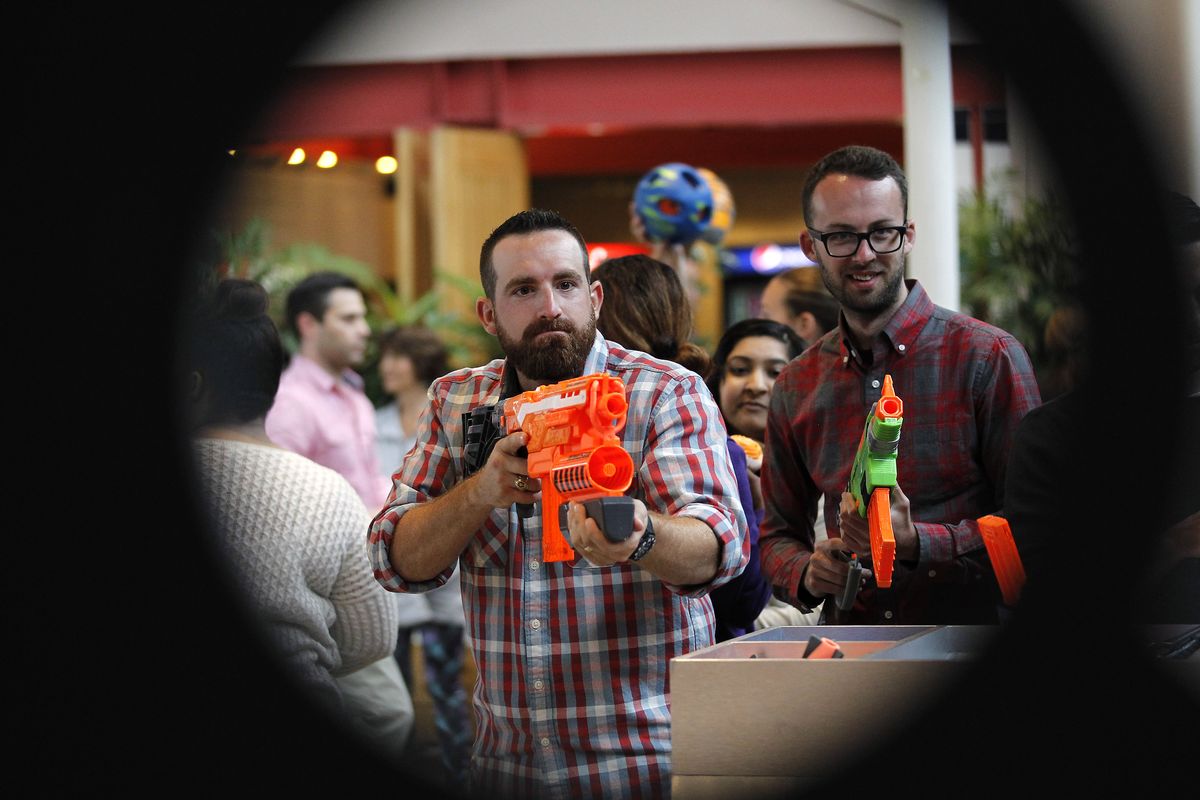 Tyler Toney of Dude Perfect and Hasbro employee Sam Proctor shoot Nerf blasters at targets during a meet-and-greet at Hasbro Headquarters in Pawtucket, R.I., in 2015. Dude Perfect became YouTube sensations with their array of trick shots.  (Stew Milne/Associated Press for Hasbro)