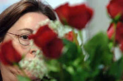 
Floral designer Deanne Graves arranges long-stem roses Friday at Hughes Florist in Post Falls where they grow and sell flowers. 
 (Jesse Tinsley / The Spokesman-Review)