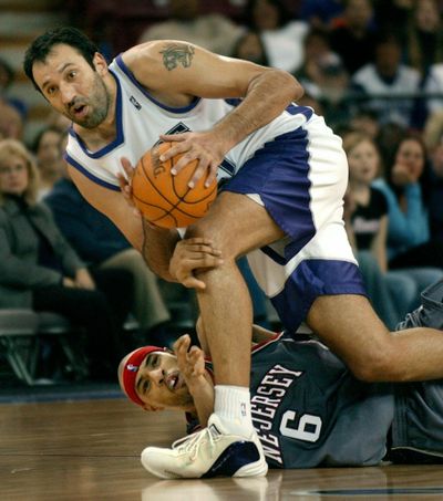 In this Nov. 30, 2003, file photo, Sacramento Kings center Vlade Divac, top, fights to keep his balance after New Jersey Nets forward Kenyon Marton tried to steal the ball during the second half of an NBA basketball game in Sacramento, Calif. NBA stars Vlade Divac, Sidney Moncrief and Jack Sikma are the headliners of the 2019 class for the Basketball Hall of Fame. The honorees were announced Saturday, April 6, 2019, in Minneapolis before the Final Four. (Steve Yeater / Associated Press)