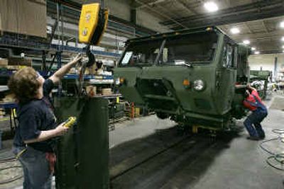 
Workers reassemble a Heavy Expanded Mobility Tactical Truck at the Oshkosh Truck plant in Oshkosh, Wis. The truck, which was damaged in Iraq, was being refurbished to be put back into military service. 
 (Associated Press photos / The Spokesman-Review)