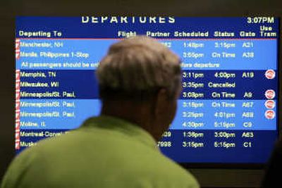 
A traveler checks Northwest departures at Detroit's metro airport in late June, when the airline canceled 1,000 flights. Associated Press
 (File Associated Press / The Spokesman-Review)
