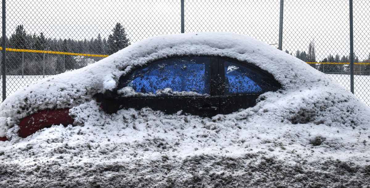 Buried Bug. A Volkswagen Beetle is up to its door handles in snow along 37th Avenue, Saturday (Dan Pelle / The Spokesman-Review)