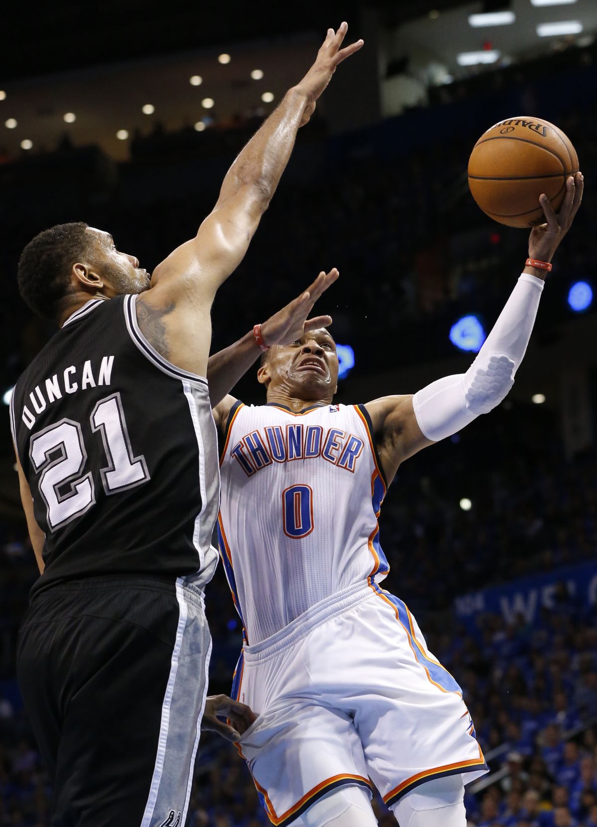 Russell Westbrook, who led the Thunder with 26 points, puts up a shot against Spurs’ Tim Duncan. (Associated Press)
