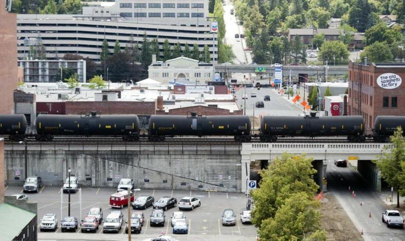 A westbound train carrying crude oil toward the coast passes through downtown Spokane Monday, July 18, 2016. (Jesse Tinsley)