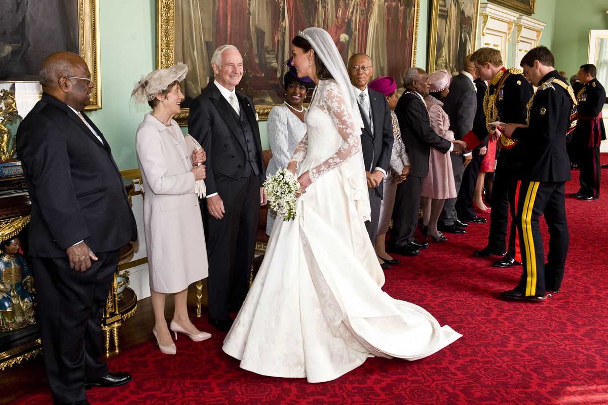Kate, the Duchess of Cambridge, center, speaks with the Governor General of Canada David Johnston, third from left, and his wife Sharon Johnston, second from left, at Buckingham Palace, following her wedding to Britain