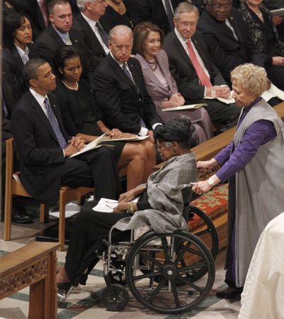 President Barack Obama, left, watches as Poet Maya Angelou, right, is escorted back to her seat after speaking during Dorothy Height's funeral services at the National Cathedral in Washington, Thursday, April 29, 2010. Seated with the president, from left are, first lady Michelle Obama, Vice President Joe Biden, House Speaker Nancy Pelosi of Calif., Senate Majority Leader Harry Reid of Nev. and House Majority Whip James Clyburn of S.C. (Haraz Ghanbari / Associated Press)