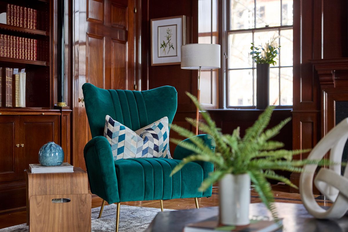 A statement green chair is accented with a toss pillow with green accents.  (Provided photo)