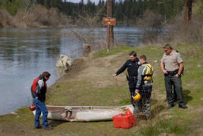 
Rescue workers, law enforcement and volunteers examine a damaged canoe Saturday believed to be owned by an 18-year-old man missing in the area of Plese Flats along the Spokane River at Riverside State Park. 
 (Brian Plonka / The Spokesman-Review)