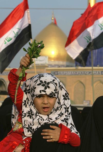 A girl chants slogans during a protest Friday in Karbala, Iraq, against the proposed U.S.-Iraq security pact.   (Associated Press / The Spokesman-Review)