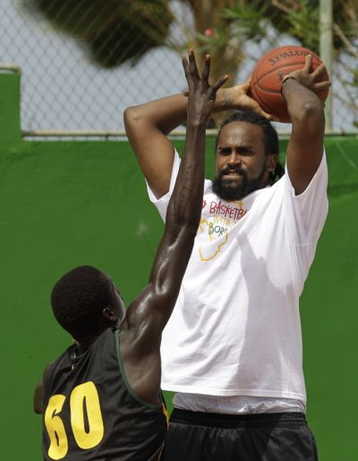 A young African player defends against New York Knicks' Ronny Turiaf during a Basketball Without Borders training session in Dakar, Senegal, in early August.  (Rebecca Blackwell / Associated Press)