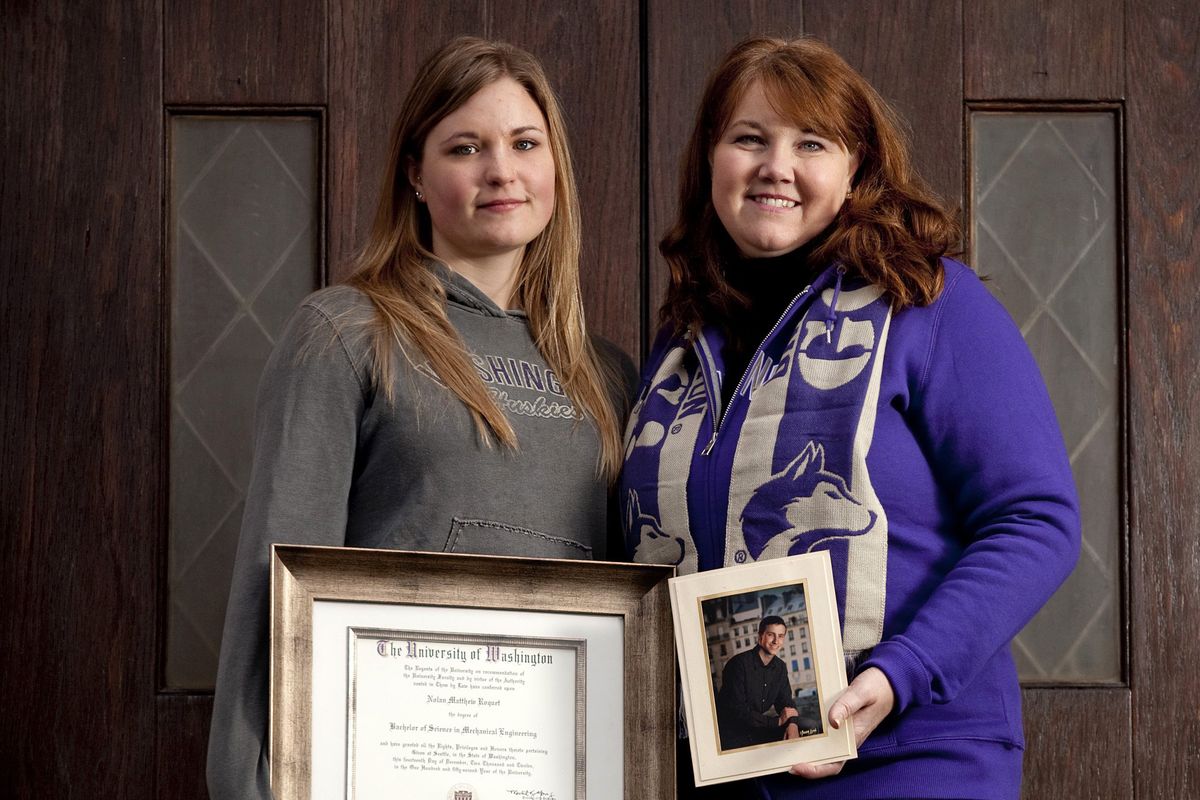 Kacie Roquet, left, and her mother-in-law, Sandy Roquet, stand with Nolan Roquet’s photo and posthumous degree in mechanical engineering from the University of Washington last week. (Bettina Hansen)