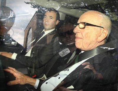 News Corp. chairman Rupert Murdoch, right, rides with News International general manager Will Lewis as they leave headquarters on July 15, 2011, in London.  (Peter Macdiarmid)