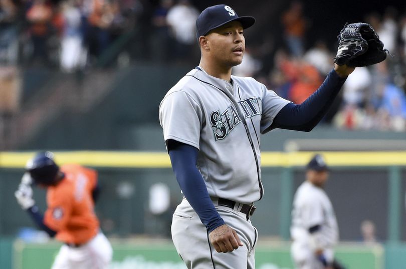 Mariners starter Taijuan Walker waits for a new ball as Astros’ Carlos Correa, left, rounds the bases after hitting a home run in the first inning. (Eric Christian Smith / Associated Press)
