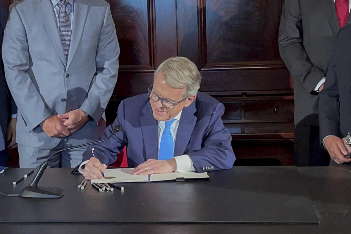 Ohio Governor Mike DeWine signs an executive order allowing college athletes in Ohio to earn money off their name, image and likeness at the Ohio Statehouse in Columbus, Ohio, in this Monday, June 28, 2021, file photo. The NCAA Board of Directors is expected to greenlight one of the biggest changes in the history of college athletics when it clears the way for athletes to start earning money based on their fame and celebrity without fear of endangering their eligibility or putting their school in jeopardy of violating amateurism rules that have stood for decades.  (Associated Press)
