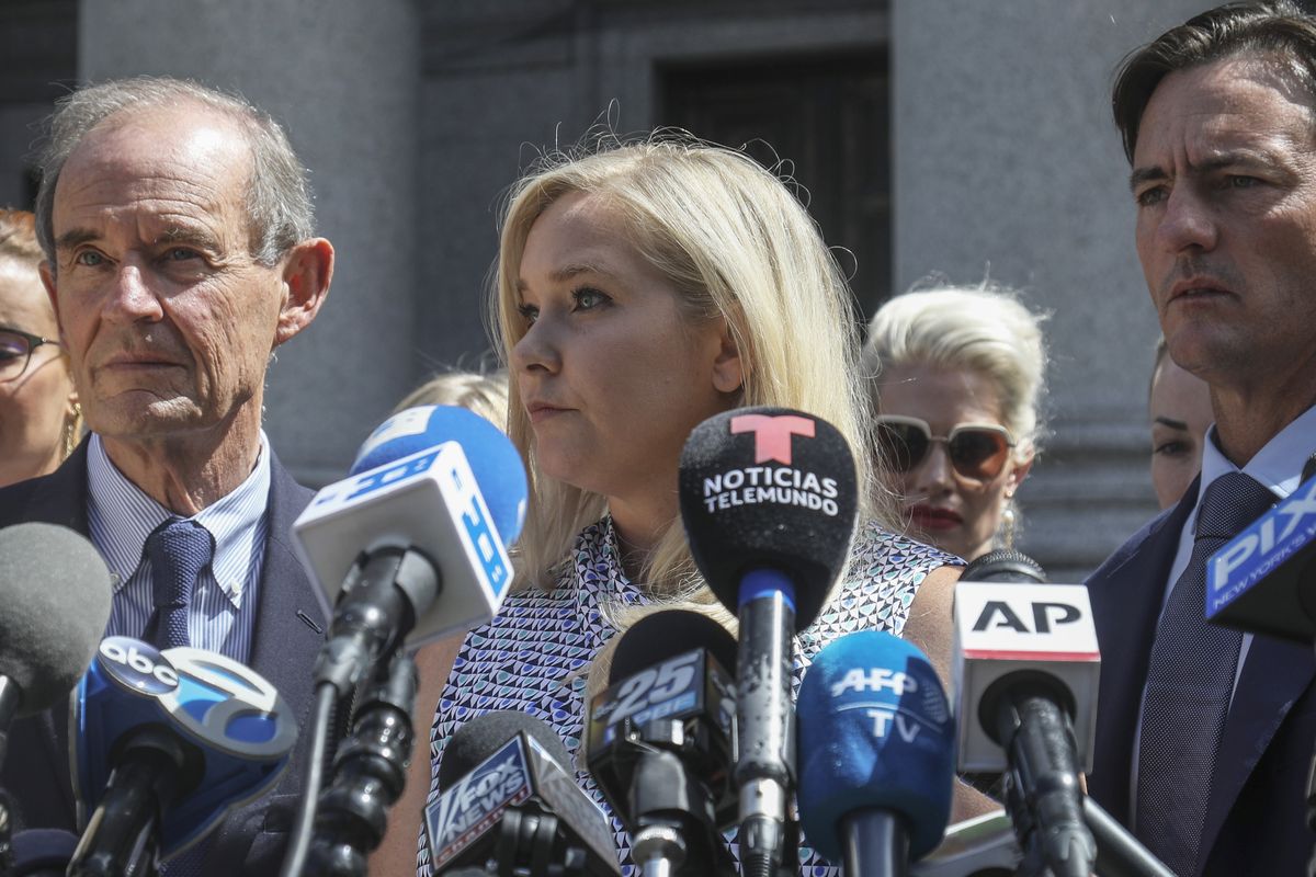 In this Aug. 27, 2019 photo, Virginia Giuffre, center, who says she was trafficked by sex offender Jeffrey Epstein, holds a news conference outside a Manhattan court in New York. On Monday, Aug. 9, 2021, Giuffre sued Prince Andrew saying he sexually assaulted her when she was 17. Lawyers for Giuffre filed the lawsuit in Manhattan federal court.  (Bebeto Matthews)