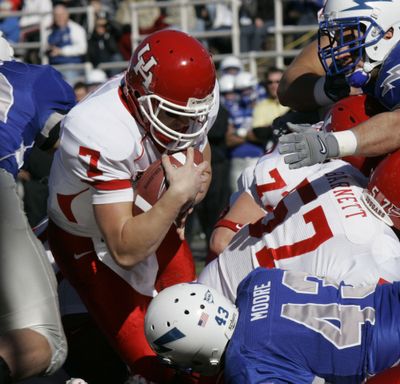 Houston quarterback Case Keenum plows through Air Force’s defense for a first-half touchdown.  (Associated Press / The Spokesman-Review)