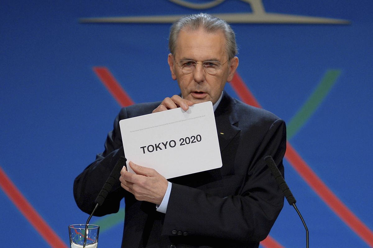 In this Saturday, Sept. 7, 2013 photo, International Olympic Committee (IOC) President Jacques Rogge shows the name of the city of Tokyo elected to host the 2020 Summer Olympics in Buenos Aires, Argentina. The International Olympic Committee on Sunday, Aug, 29, 2021 says Jacques Rogge who led the organization as president for 12 years, has died. He was 79.  (Fabrice Coffrini)