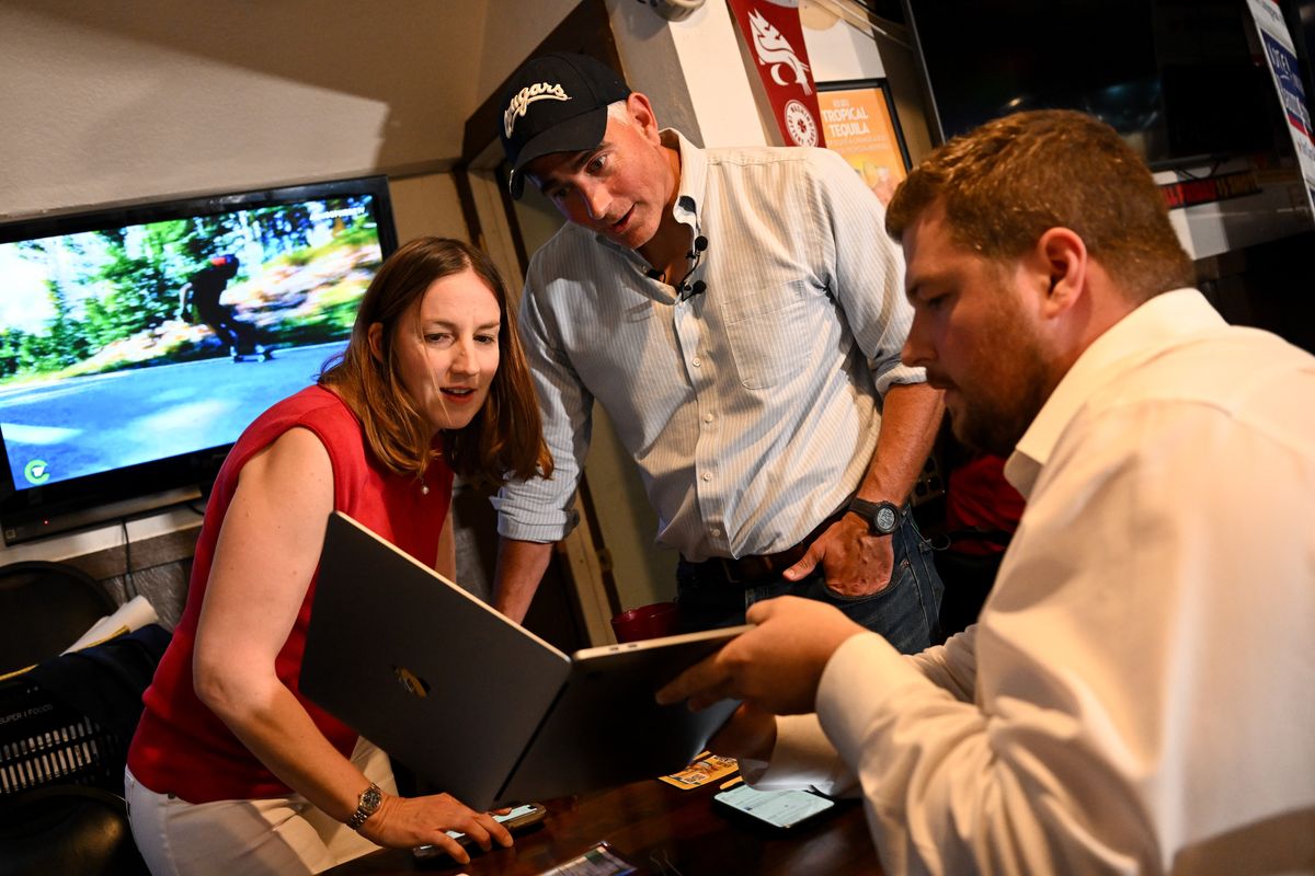 Republican congressional candidate Michael Baumgartner, who currently serves as Spokane County Treasurer, and his wife Eleanor Baumgartner react as they watch voting results come in during a primary election party on Tuesday at the Swinging Doors in Spokane.  (Tyler Tjomsland/The Spokesman-Review)